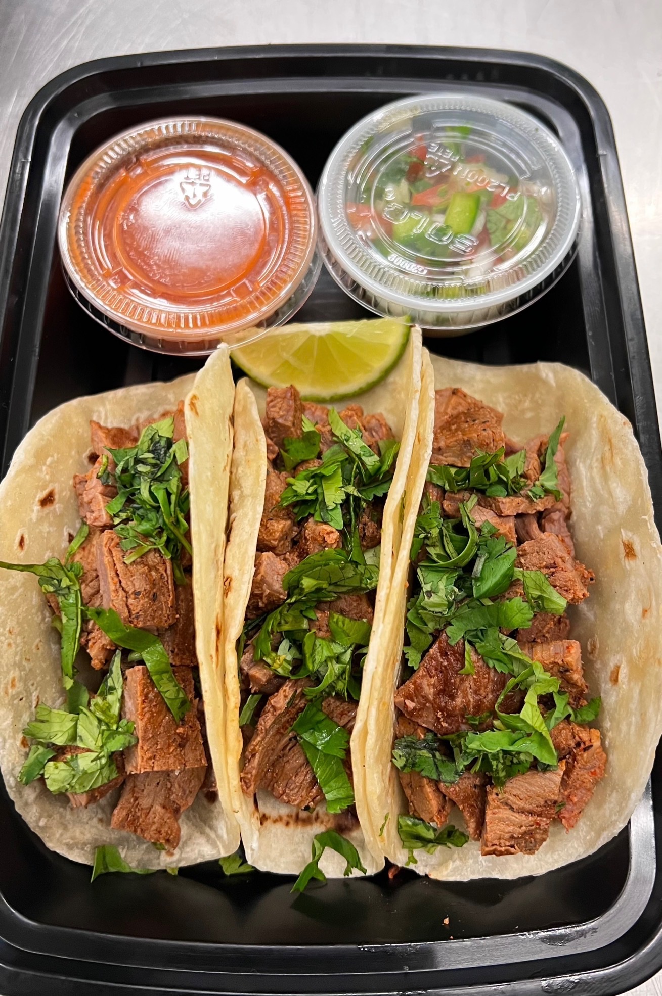 Carne asada street tacos with cilantro, lime, and salsa
