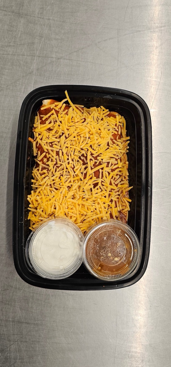 Red Chile Chicken Enchiladas topped with shredded cheese, served with sour cream and salsa